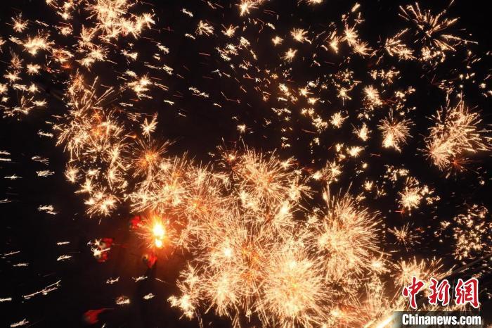 灼熱的鐵水在空中迸散。在空中形成“鐵花火雨”的景象，似天女散花，似群星漫天，如夢如幻，美不勝收。侯奇志 攝</p>
<p>